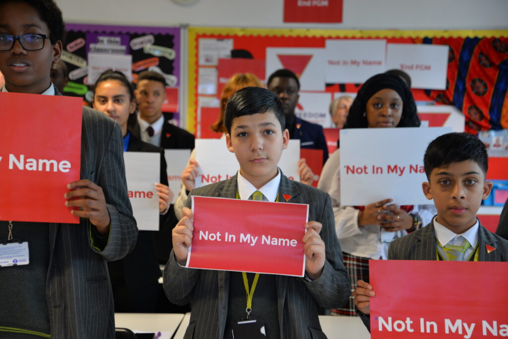Boys holding Not in My Name signs for Freedom Charity’s campaign against FGM and forced marriage